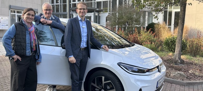 Das neue E-Auto im Fuhrpark mit Bürgermeister, Erstem Beigeordneten und Klimaschutzmanagerin.